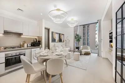 a kitchen and living room with a table and chairs at Burj Khalifa & Downtown Skyline View Apartment in Dubai