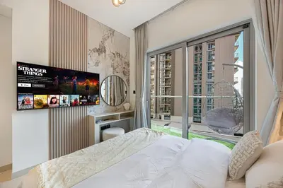 a bedroom with a bed and a large window at Burj Khalifa & Downtown Skyline View Apartment in Dubai