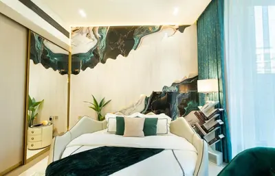 a bedroom with a bed and a painting on the wall at Binghatti Aurora, JVC Dubai - Unique Round Bed Experience with pool view in Dubai