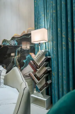 a lamp with a stack of books next to a bed at Binghatti Aurora, JVC Dubai - Unique Round Bed Experience with pool view in Dubai