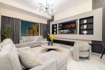 a living room with a couch and a table at Beachfront Spacious Apartment with Sea & Palm Views in Dubai