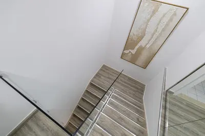 a staircase in a house with a picture on the wall at Luxury Duplex Penthouse with Stunning Marina Views in Dubai
