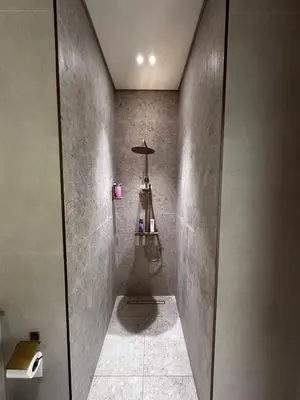 a bathroom with a walk in shower with a ladder at Modern1BR Binghatti Phantom Private pool JVC in Dubai
