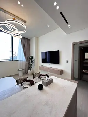 a living room with a bed and a flat screen tv at Modern1BR Binghatti Phantom Private pool JVC in Dubai