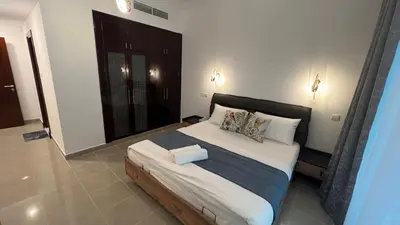 a bedroom with a large bed with two pillows at Spacious and Cozy 1BR Opal Tower Stunning Marina View in Dubai