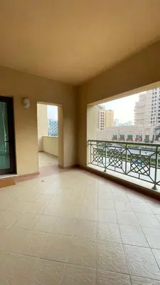 an empty room with two large windows and a balcony at Luxury 1-Bedroom, Golden Mile Palm Jumeirah in Dubai
