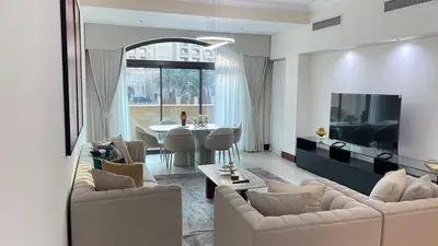 a living room with two couches and a dining room at Luxury 1-Bedroom, Golden Mile Palm Jumeirah in Dubai