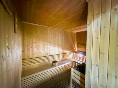 a wooden sauna with a small bucket in it at Luxury Studio at Marina Star - Near JBR - Marina in Dubai