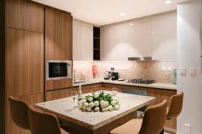 a kitchen with a table with a bowl of fruit on it at Ultra-Luxury Apartment | Burj Khalifa Skyline Pool in Dubai