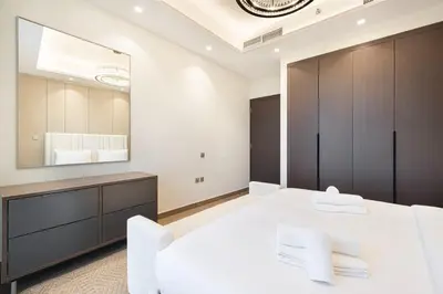 a bedroom with a white bed and a large mirror at 2 bedroom in heart of Business Bay - Dubai in Dubai