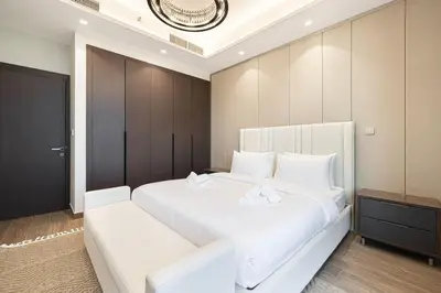 a bedroom with a large white bed with white pillows at 2 bedroom in heart of Business Bay - Dubai in Dubai