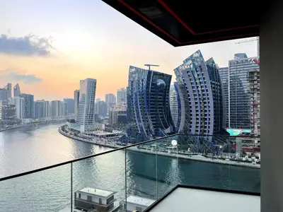 a view of a city with a river and buildings at Luxury 2BR Apt | Infinity Pool with Burj View in Dubai