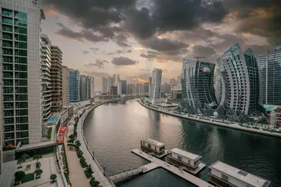 a river in the middle of a city with tall buildings at Luxury 2BR Apt | Infinity Pool with Burj View in Dubai