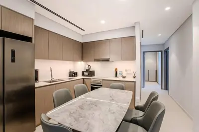 a kitchen with a table and chairs in a room at Ultra-luxury apartment |Stunning Burj Khalifa view in Dubai