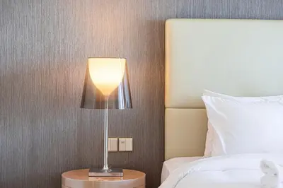 a lamp sitting on a table next to a bed at 2 bedroom in heart of Business Bay - Dubai in Dubai