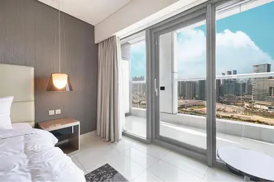 a bedroom with a bed and a large window at 2 bedroom in heart of Business Bay - Dubai in Dubai