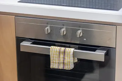 a towel hanging on the handle of an oven at 2 bedroom in heart of Business Bay - Dubai in Dubai
