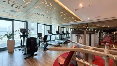 a gym with treadmills and ellipticals in a building at 2 bedroom in heart of Business Bay - Dubai in Dubai