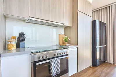 a kitchen with a stove and a refrigerator at Frank Porter - Stella Maris in Dubai