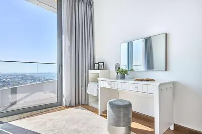 a white desk in a room with a large window at Frank Porter - Stella Maris in Dubai