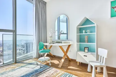 a desk and chairs in a room with a window at Frank Porter - Stella Maris in Dubai