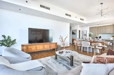 a living room with a flat screen tv on a wall at Frank Porter - Stella Maris in Dubai