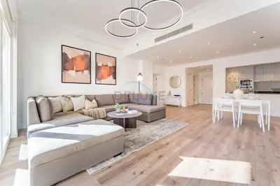 a living room with a couch and a table at Exclusive Waterfront Residence with Private Beach Access, Near Palm Jumeirah Mall and Restaurants - Jash Hamad Shoreline B18, Palm Jumeirah by Deluxe Holiday Homes in Dubai