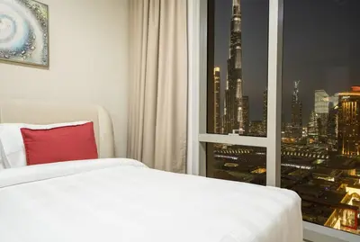 a room with a bed and a window with a view of a city at 2BR Vida Dubai Mall Burj Khalifa & Fountain View in Dubai