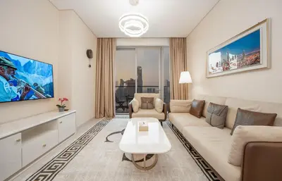 a living room with a white couch and a table at 2BR Vida Dubai Mall Burj Khalifa & Fountain View in Dubai