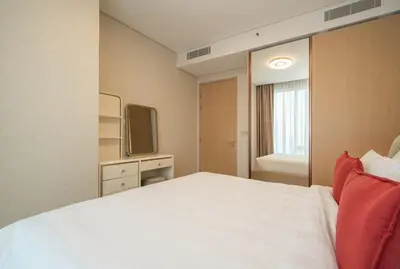 a bedroom with a white bed and a television at 2BR Vida Dubai Mall Burj Khalifa & Fountain View in Dubai