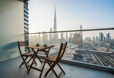 a table and two chairs on a balcony with a view at 2BR Vida Dubai Mall Burj Khalifa & Fountain View in Dubai