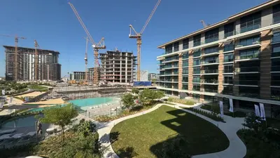 a view of a building under construction with cranes at Contemporary 2BR in Central Park Viridian in Dubai