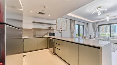 a kitchen with white cabinets and a counter top at Contemporary 2BR in Central Park Viridian in Dubai