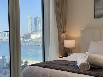 a bedroom with a large window with a view of the ocean at BRAND NEW 2 BDR apartment with beach access in Dubai
