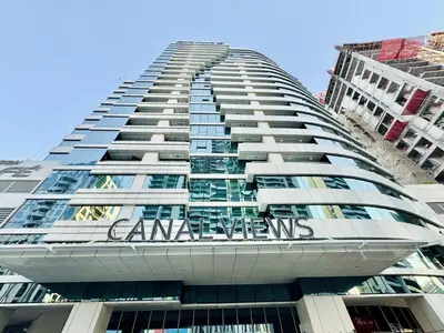 a tall building with a sign on the side of it at Homes2Retreat - Stylish 1BR with Balcony in Business Bay in Dubai