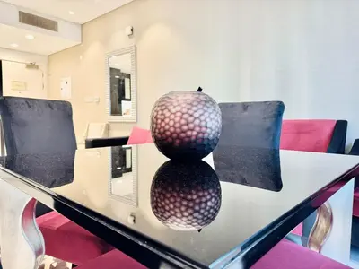 a vase sitting on top of a glass table at Homes2Retreat - Stylish 1BR with Balcony in Business Bay in Dubai