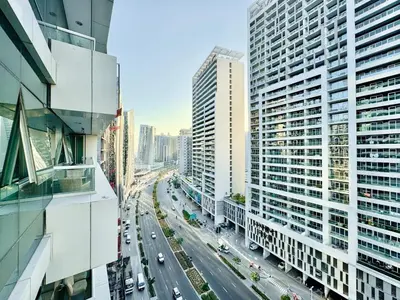 a city with tall buildings and a street with cars at Homes2Retreat - Stylish 1BR with Balcony in Business Bay in Dubai