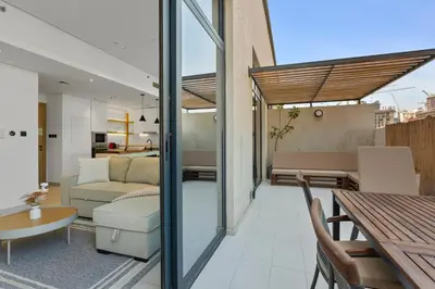 a living room with a couch and a table at Urban Chic 1 Bedroom with big Balcony Kitchen in JVC in Dubai
