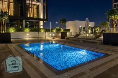a swimming pool in the middle of a building at Modern 1BR Azizi Riviera with Pool & Gym in Dubai