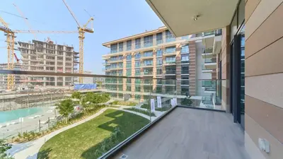 an apartment balcony with a view of a building at Modern 2BR in Viridian Central Park City Walk in Dubai