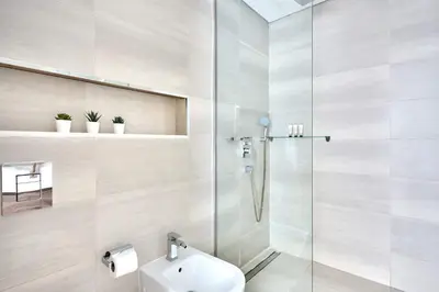 a bathroom with a shower and a toilet and a sink at Frank Porter - Mada Residences in Dubai
