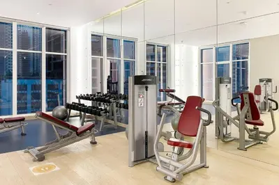 a gym with cardio equipment and a mirror at Modern Studio in Business Bay - Canal & City Views - Gym & Pool in Dubai