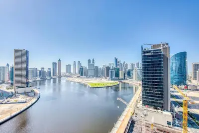 a view of a river in a city with tall buildings at Modern Studio in Business Bay - Canal & City Views - Gym & Pool in Dubai