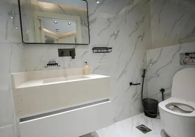 a white bathroom with a sink and a toilet at Luxury 3 Bed flat in Marina crown in Dubai