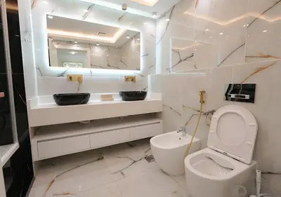 a bathroom with a toilet and a sink and a mirror at Luxury 3 Bed flat in Marina crown in Dubai