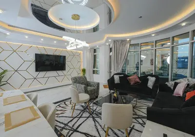 a living room with a couch and chairs and a tv at Luxury 3 Bed flat in Marina crown in Dubai
