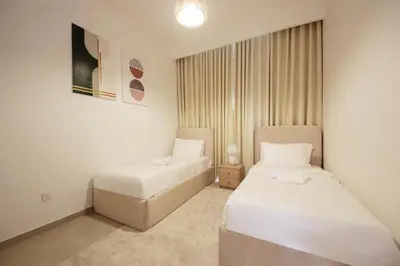 a room with two beds and a sink in it at Silk Valley - Luxury Villa | Steps to Park & Pool in Dubai