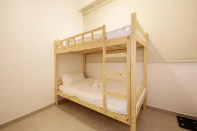 a wooden bunk bed with a ladder in a room at Silk Valley - Luxury Villa | Steps to Park & Pool in Dubai