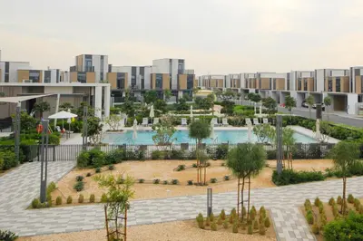 an aerial view of a park with buildings in the background at Silk Valley - Luxury Villa | Steps to Park & Pool in Dubai