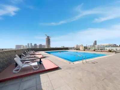 a swimming pool on the roof of a building at Relaxing Studio with Balcony & Pool at The Square Tower in Dubai